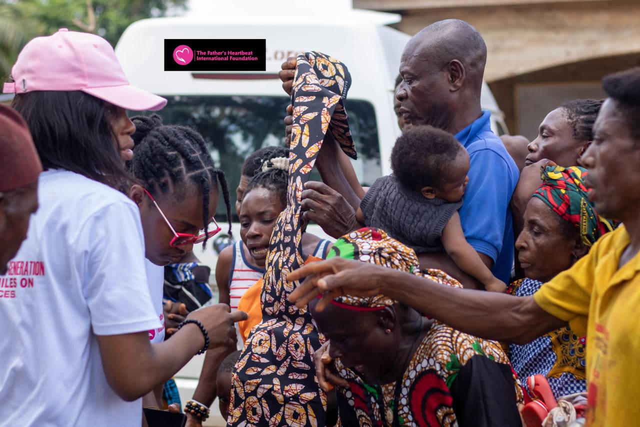 Founder smiling with a group of happy children in a village