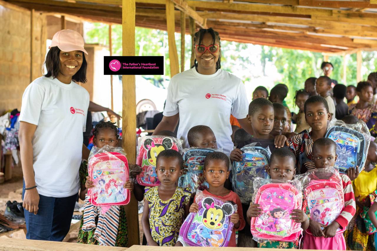 Smiling children receiving educational materials